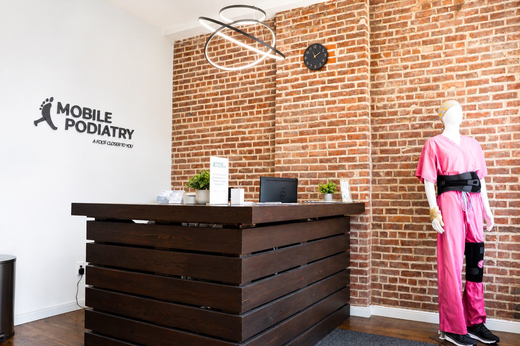 Brick-walled reception desk at the Pitkin Avenue office
